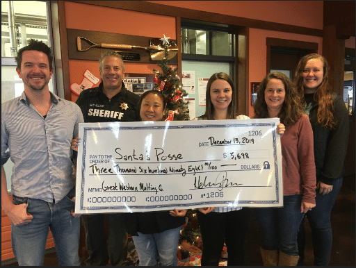 GWM Team handing a check to Santa's Posse for $3,698