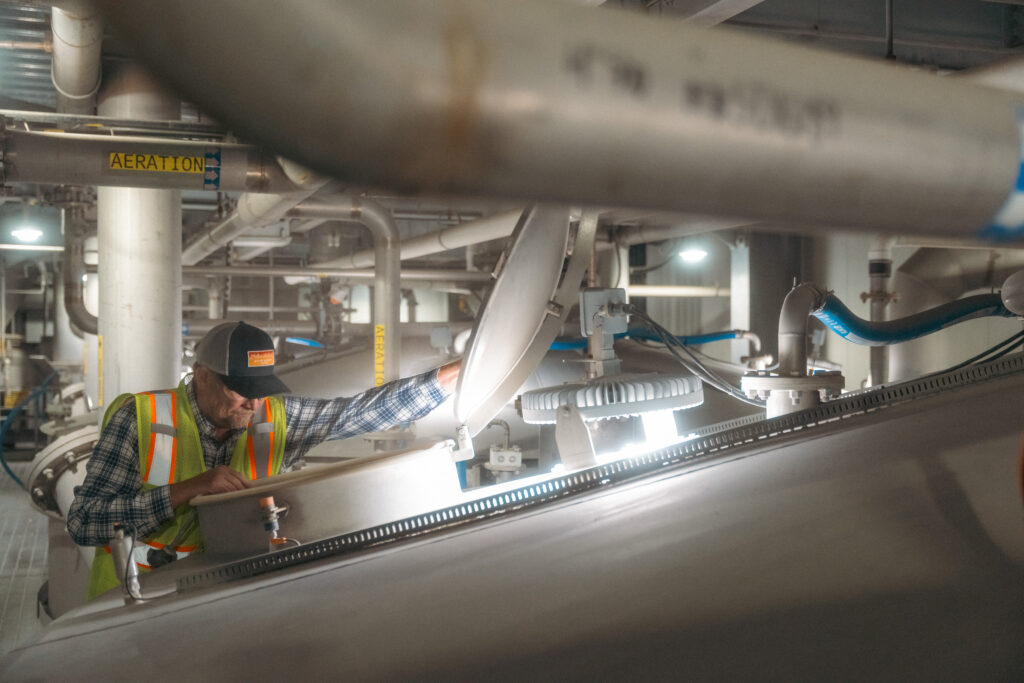 Maltster looking into the steep tank at the malting facility at Great Western Malting